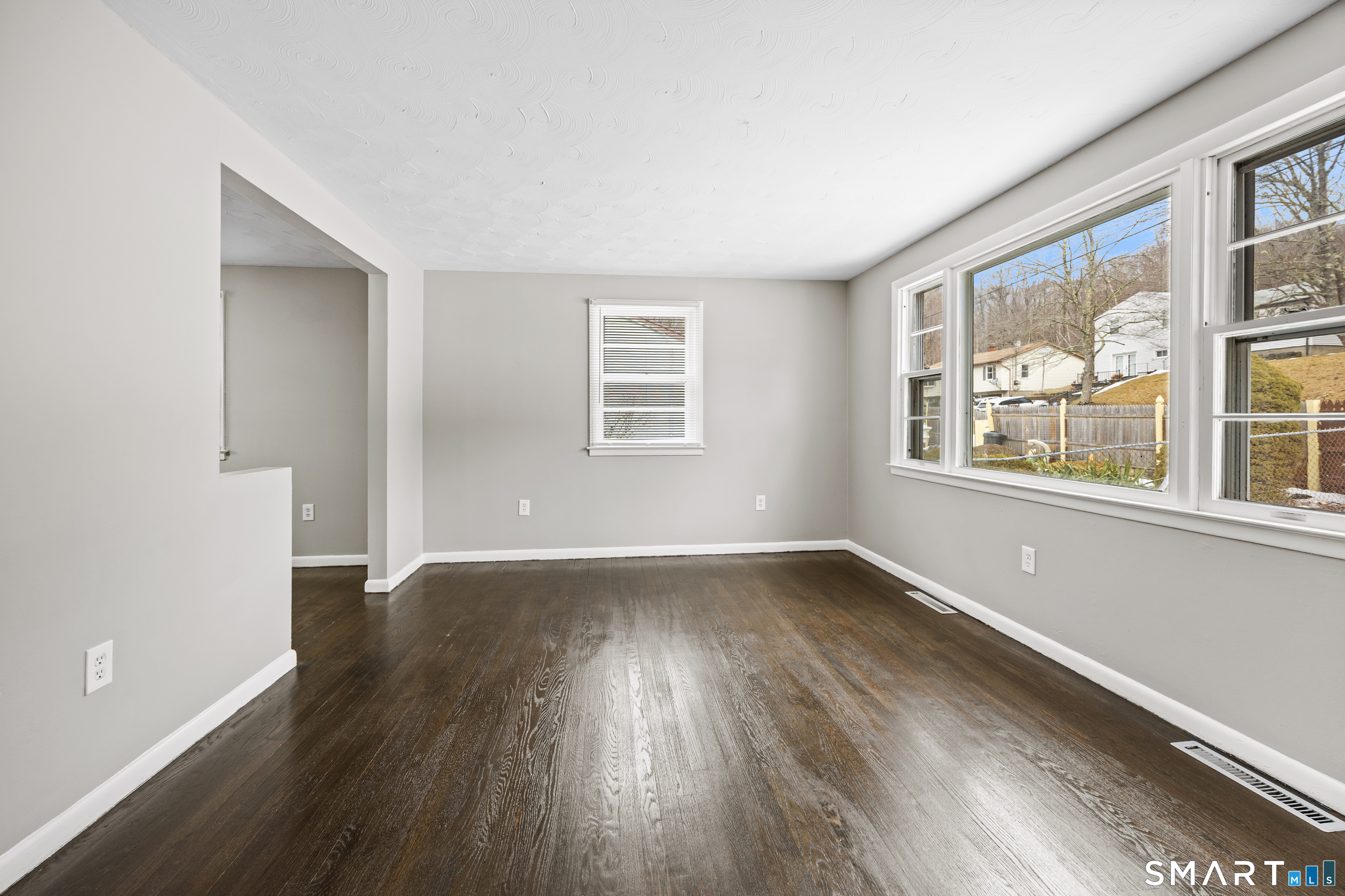 175 Devonwood Drive Waterbury, CT 06708 - Photo 3 of 30 an empty room with wooden floor and windows