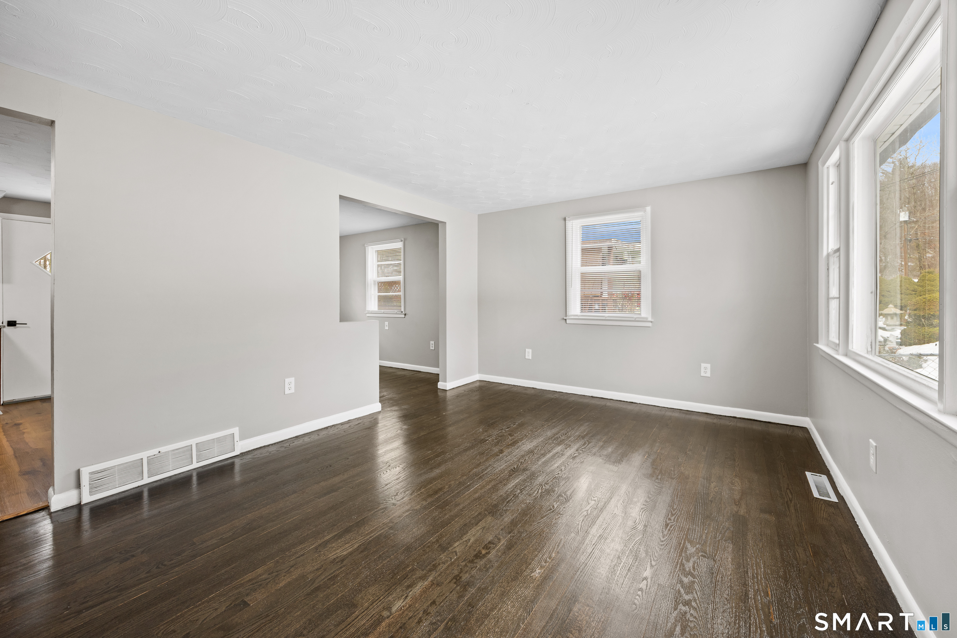 175 Devonwood Drive Waterbury, CT 06708 - Photo 4 of 30 an empty room with wooden floor and windows