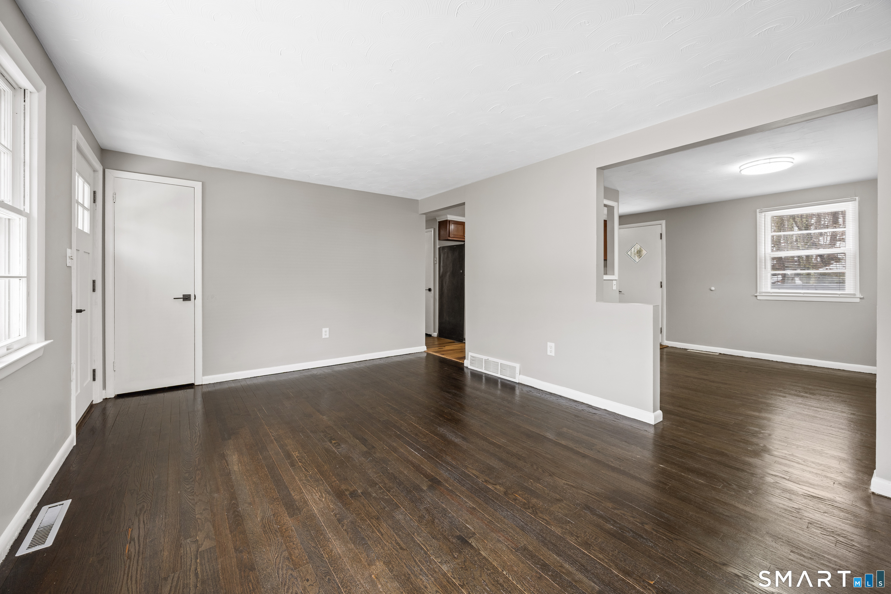 175 Devonwood Drive Waterbury, CT 06708 - Photo 5 of 30 an empty room with wooden floor and windows