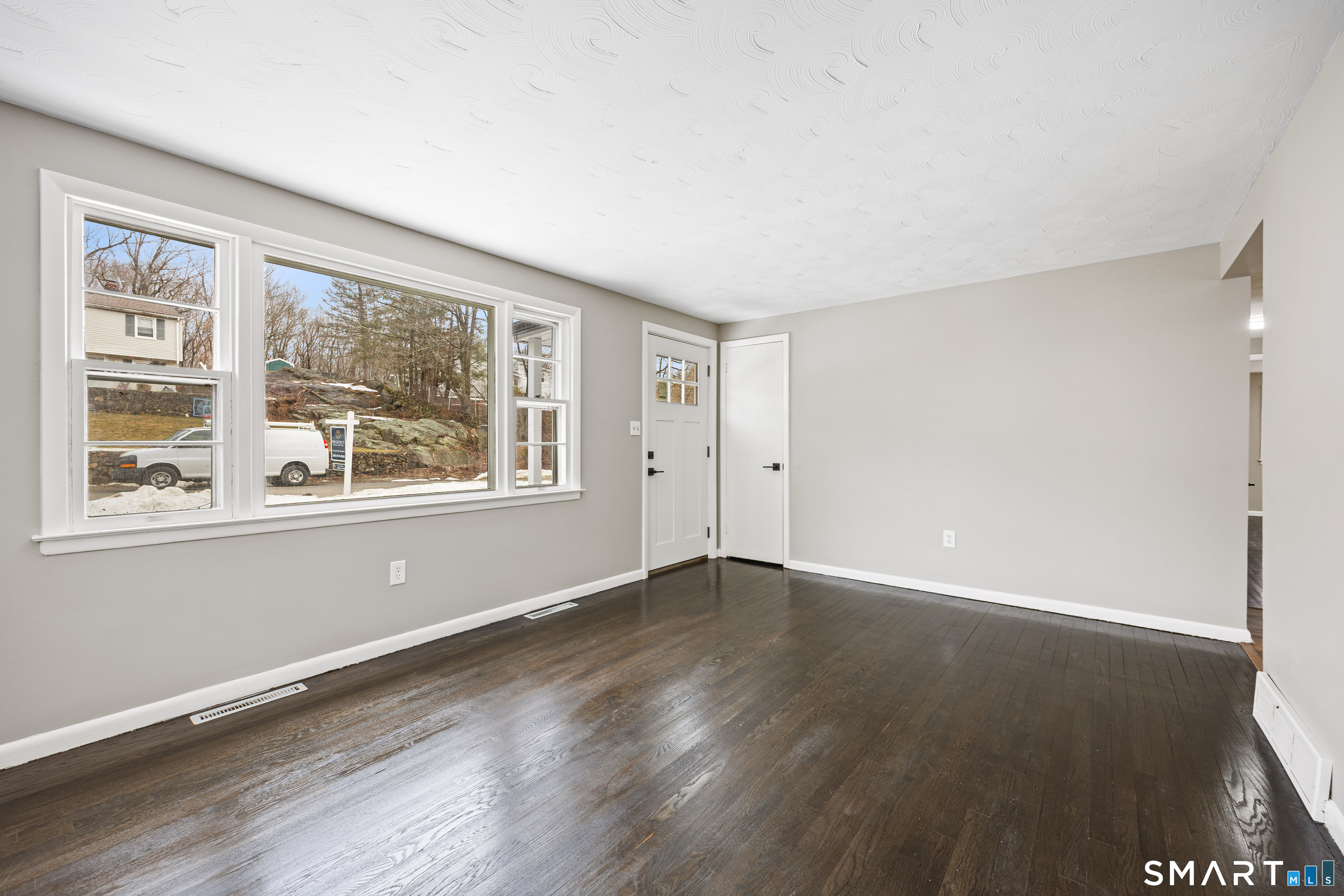 175 Devonwood Drive Waterbury, CT 06708 - Photo 6 of 30 a view of an empty room with wooden floor and a window