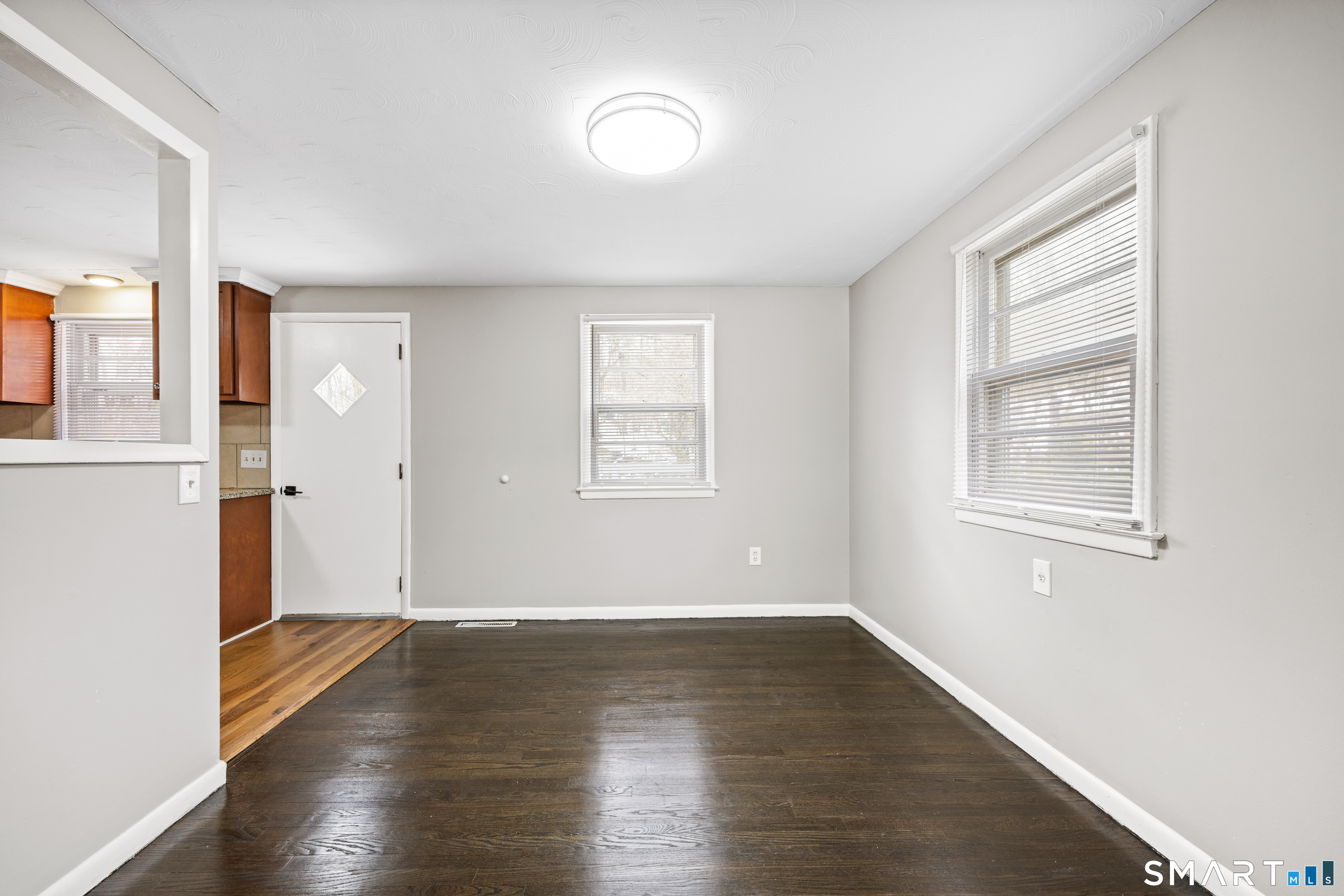 175 Devonwood Drive Waterbury, CT 06708 - Photo 7 of 30 an empty room with wooden floor and windows