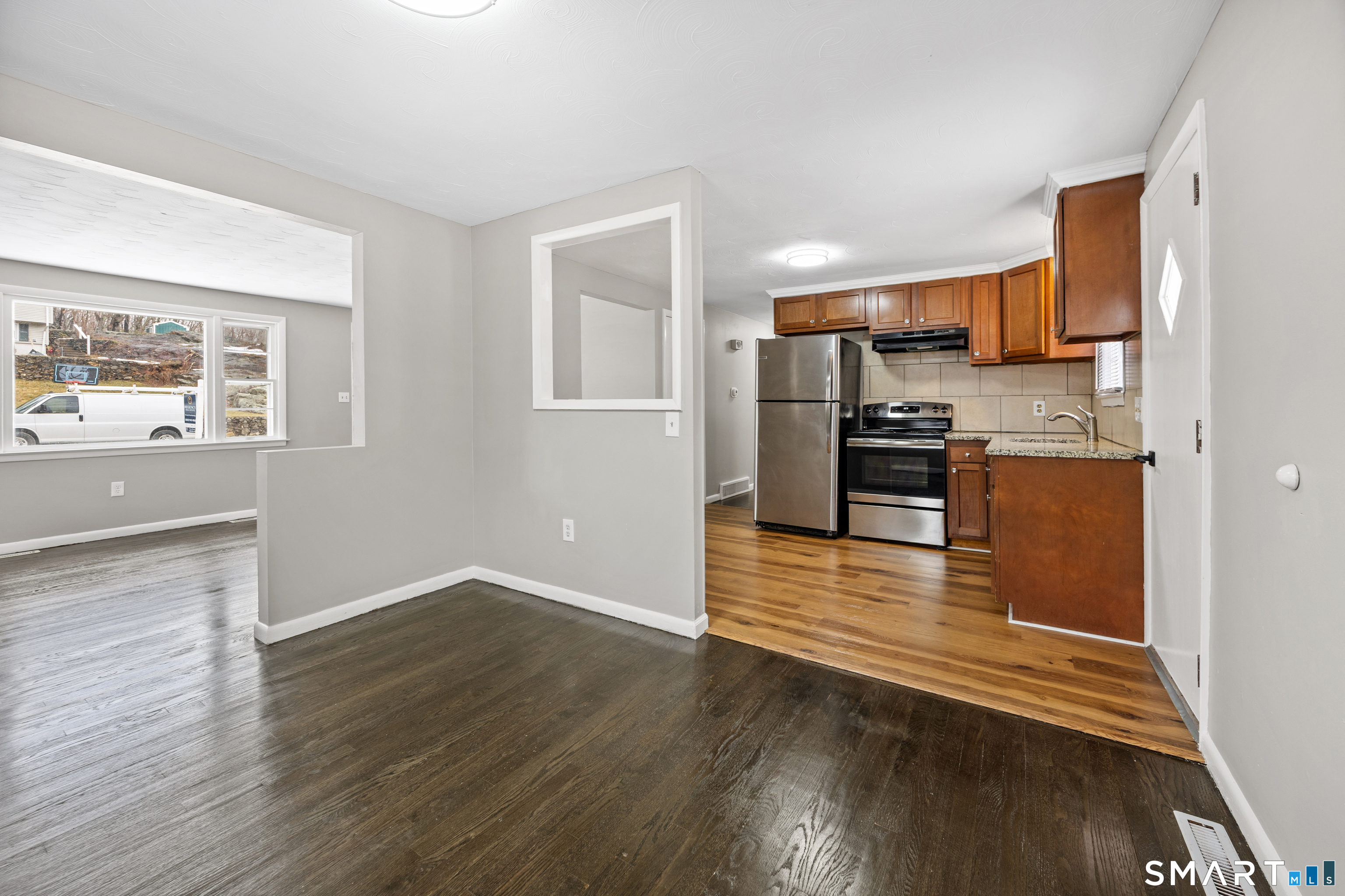 175 Devonwood Drive Waterbury, CT 06708 - Photo 8 of 30 a view of a kitchen with wooden floor and electronic appliances