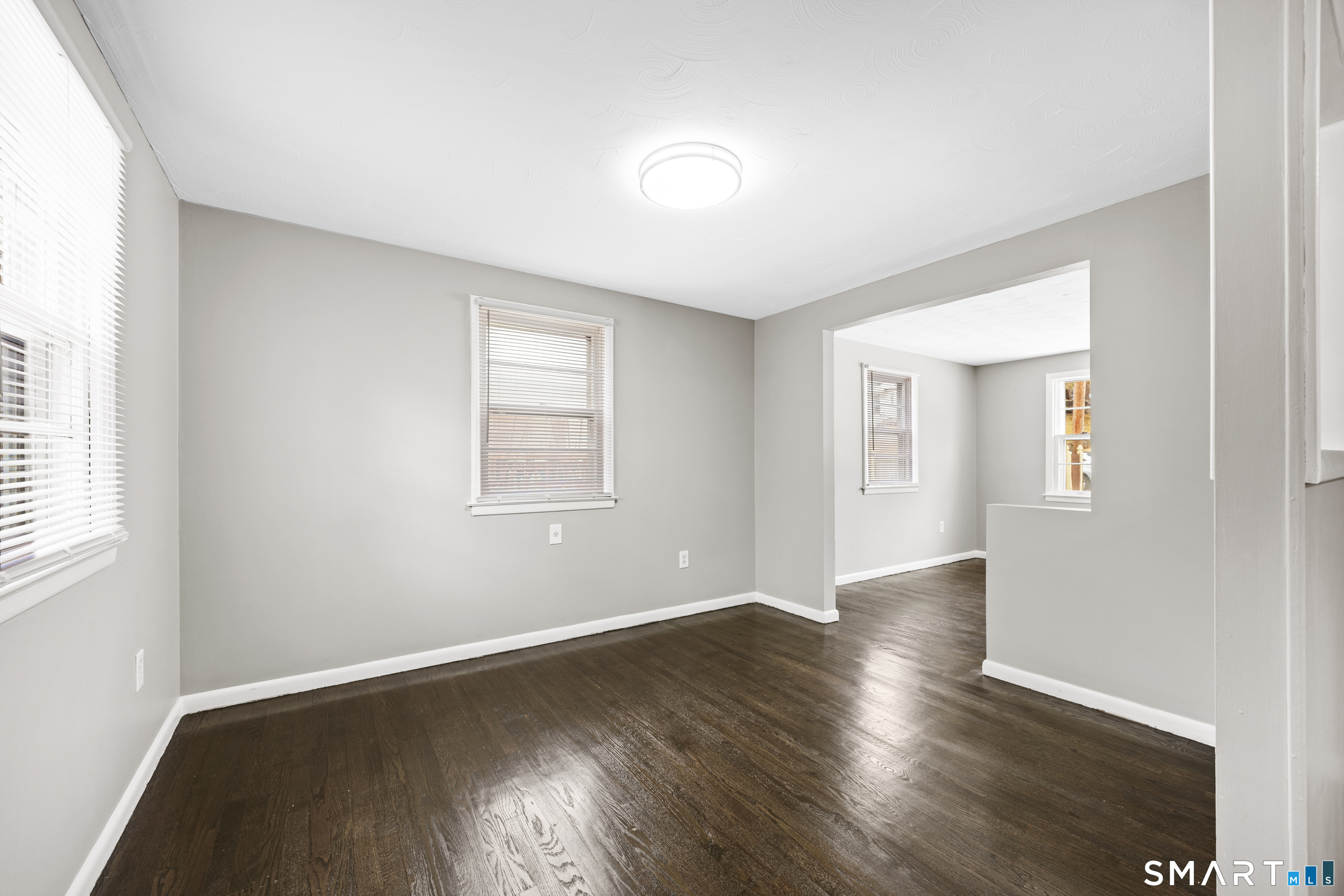 175 Devonwood Drive Waterbury, CT 06708 - Photo 9 of 30 an empty room with wooden floor and windows
