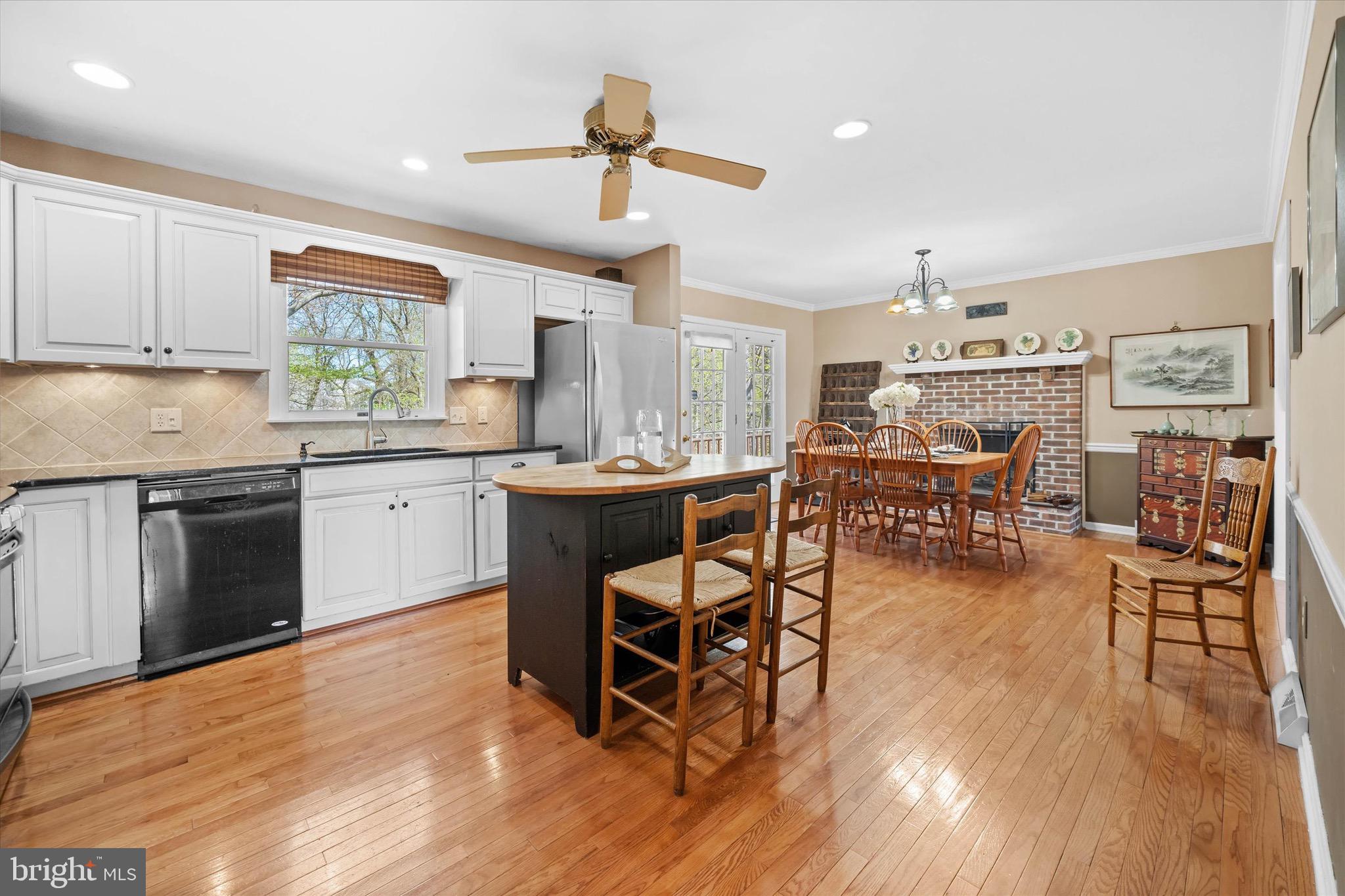 701 Christopher Drive Middletown, DE 19709 - Photo 16 of 57 a kitchen with stainless steel appliances a dining table chairs stove and white cabinets