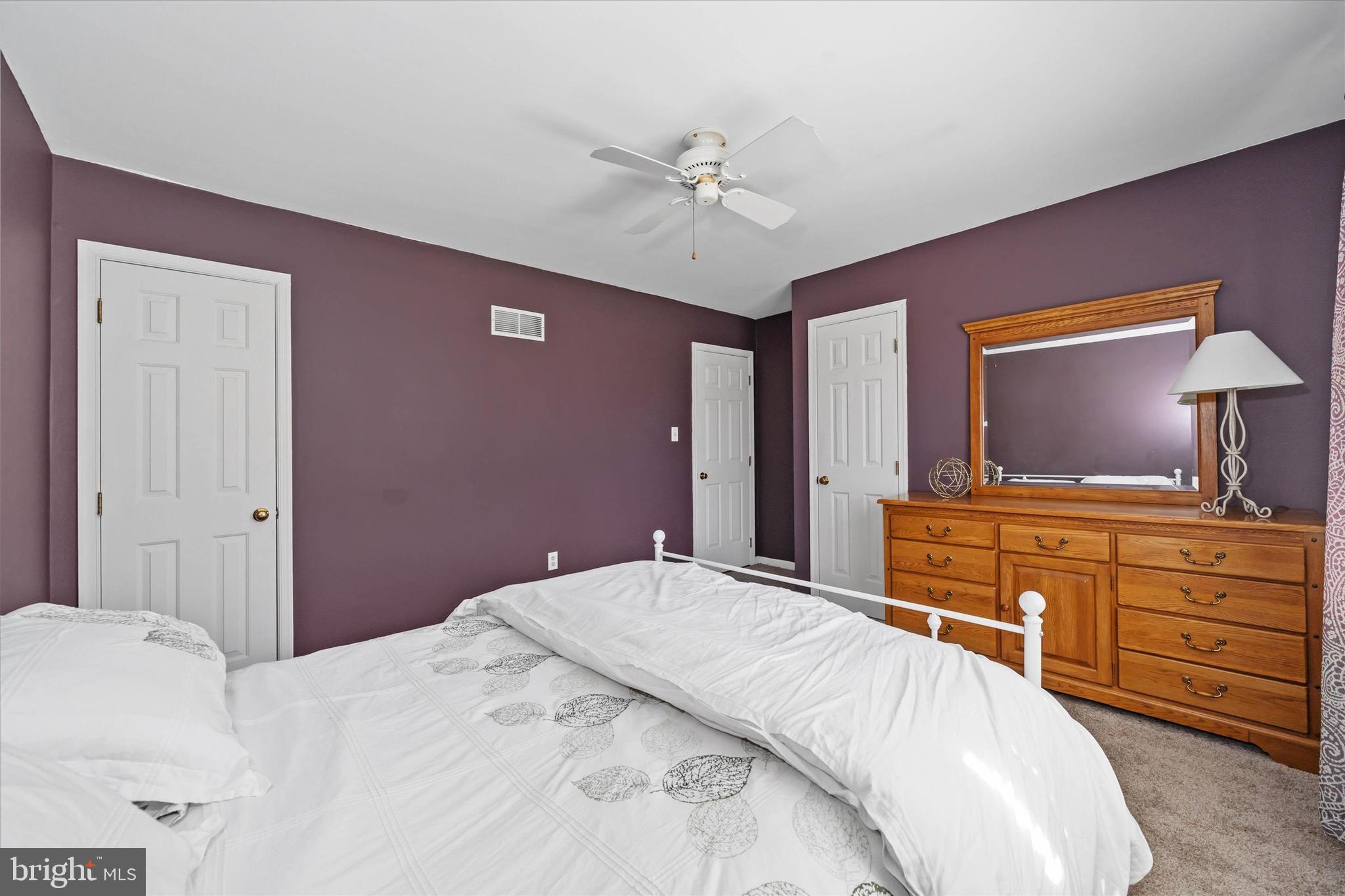 701 Christopher Drive Middletown, DE 19709 - Photo 26 of 57 a bedroom with a large bed and a chandelier