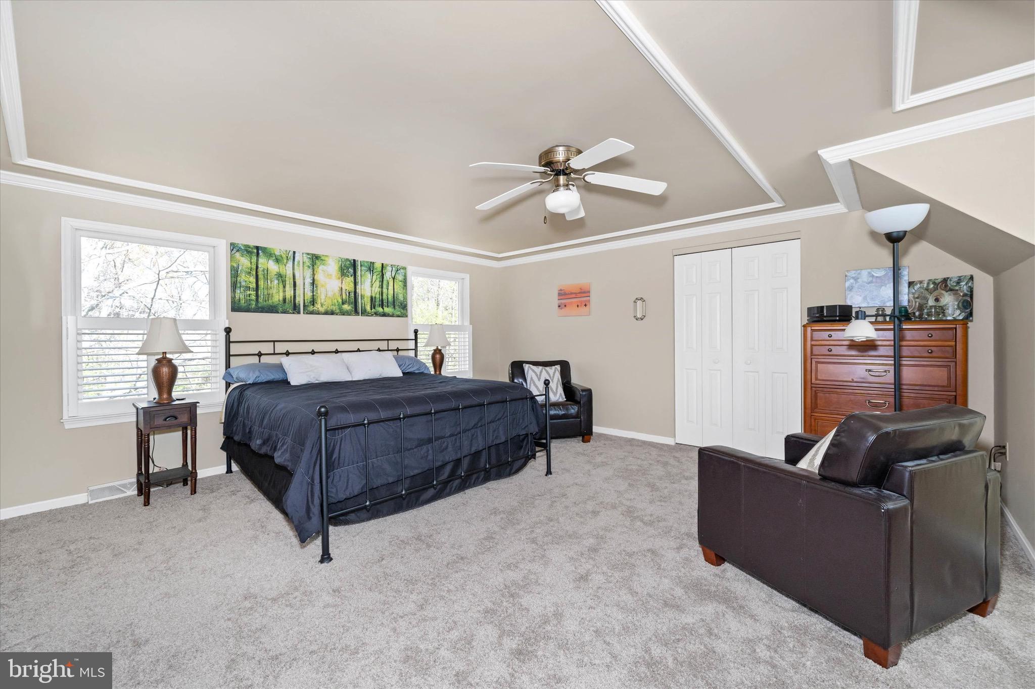 701 Christopher Drive Middletown, DE 19709 - Photo 30 of 57 a bedroom with a bed a couch and a ceiling fan