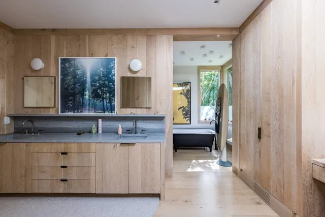 a en suite bathroom with a granite countertop sink and a mirror