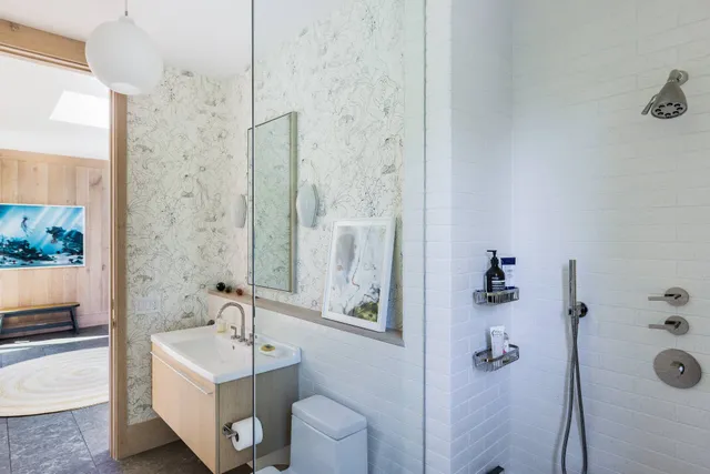 a bathroom with a tub sink and mirror