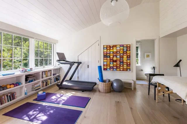 a bedroom with furniture and a large window