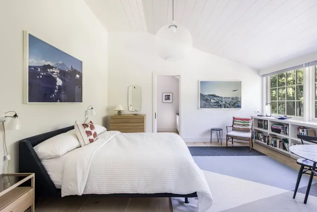 a bed room with a bed and a chair