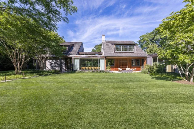 a front view of a house with a yard table and chairs