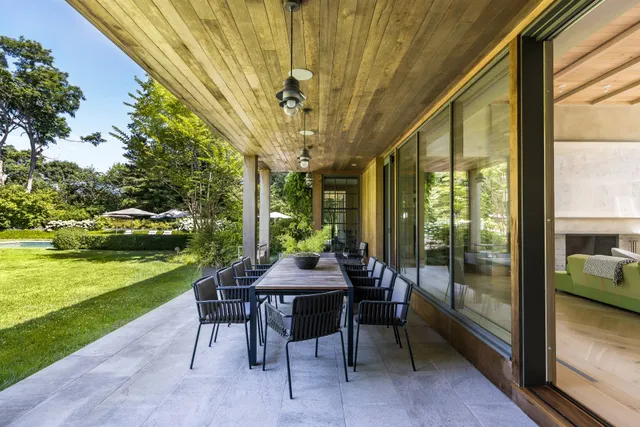 a table and chairs with the view of garden