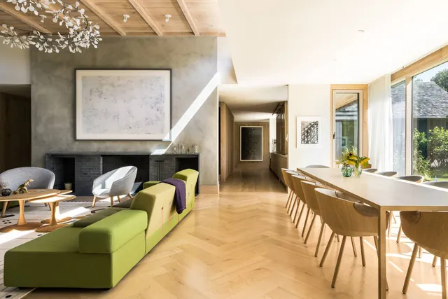 a living room with furniture a large window and a fireplace