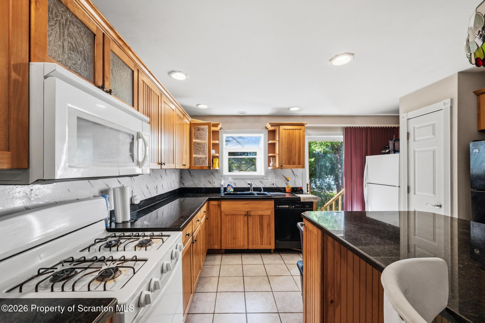518 Prospect Avenue Scranton, PA 18505 - Photo 15 of 59 a kitchen with stainless steel appliances granite countertop a stove a sink and a refrigerator
