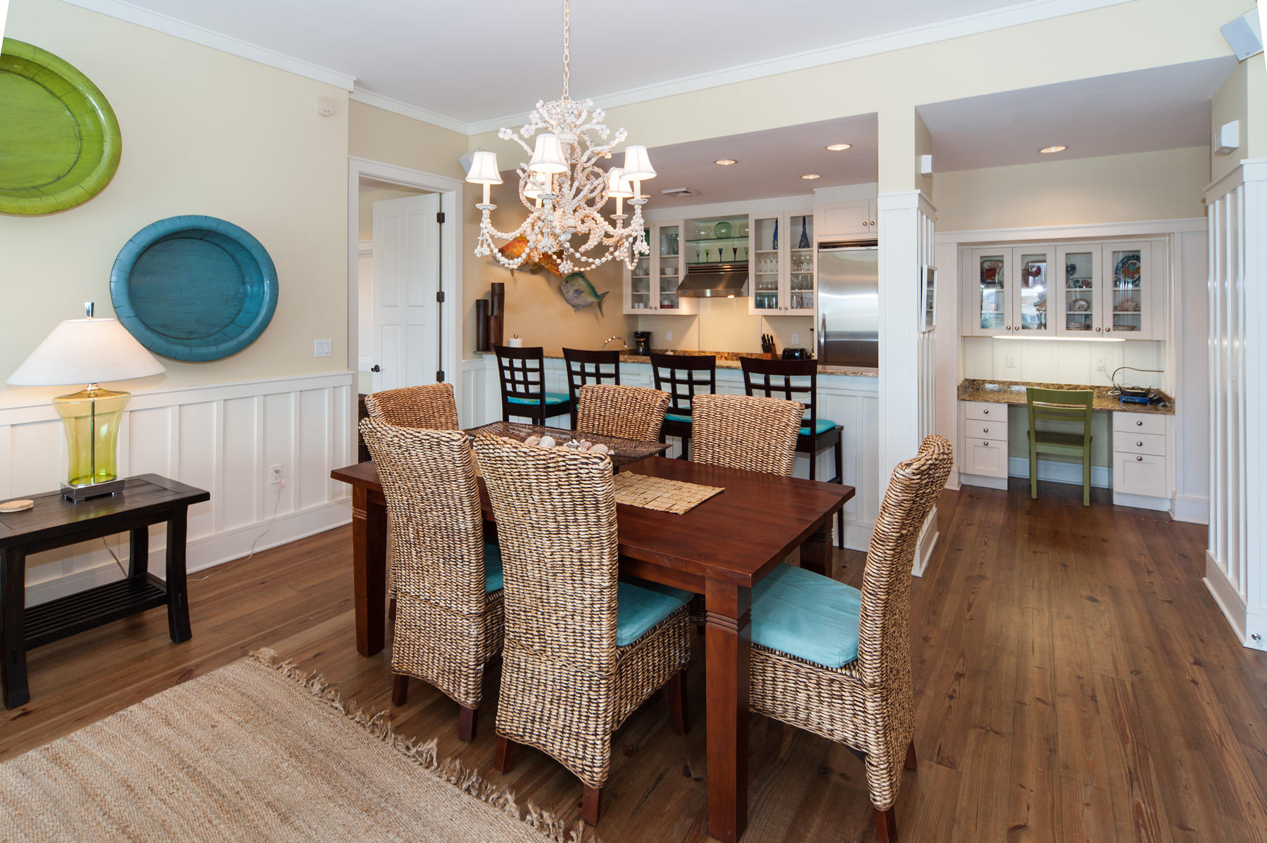 99 Compass Point Way, Unit 302 Watersound, FL 32461 - Photo 10 of 19 a dining room with furniture a chandelier and wooden floor