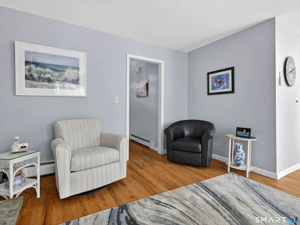 a living room with furniture and a wooden floor