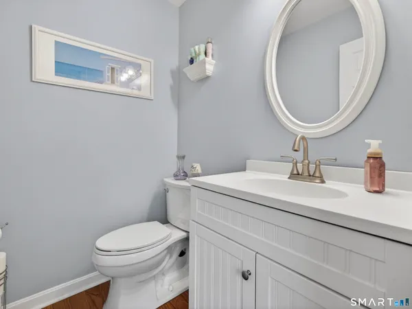 a bathroom with a sink mirror and toilet