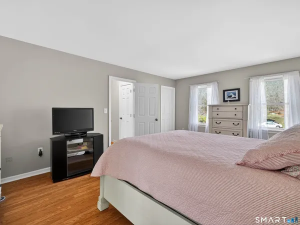 a bedroom with a bed and a flat screen tv