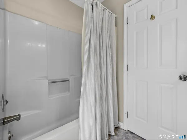 a bathroom with a shower and a glass door