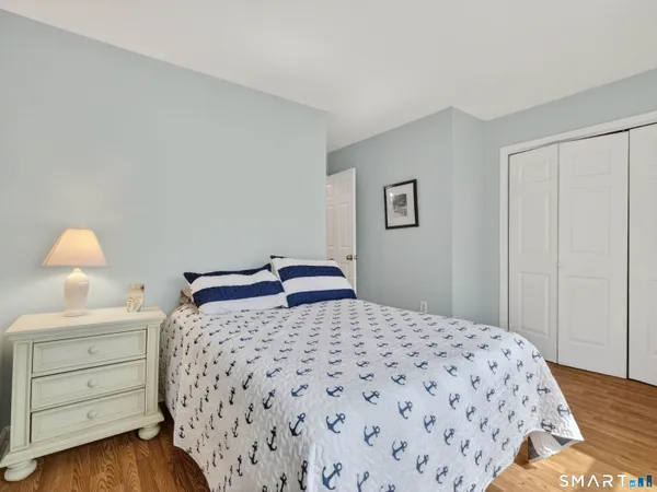 a bedroom with a bed and a lamp