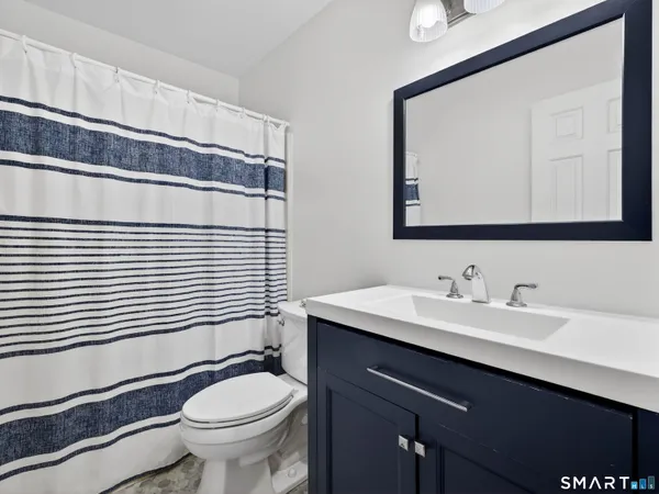 a bathroom with a sink a toilet and mirror
