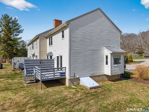 a view of a house with backyard and sitting area