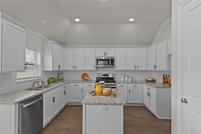 a kitchen with a sink a stove and cabinets