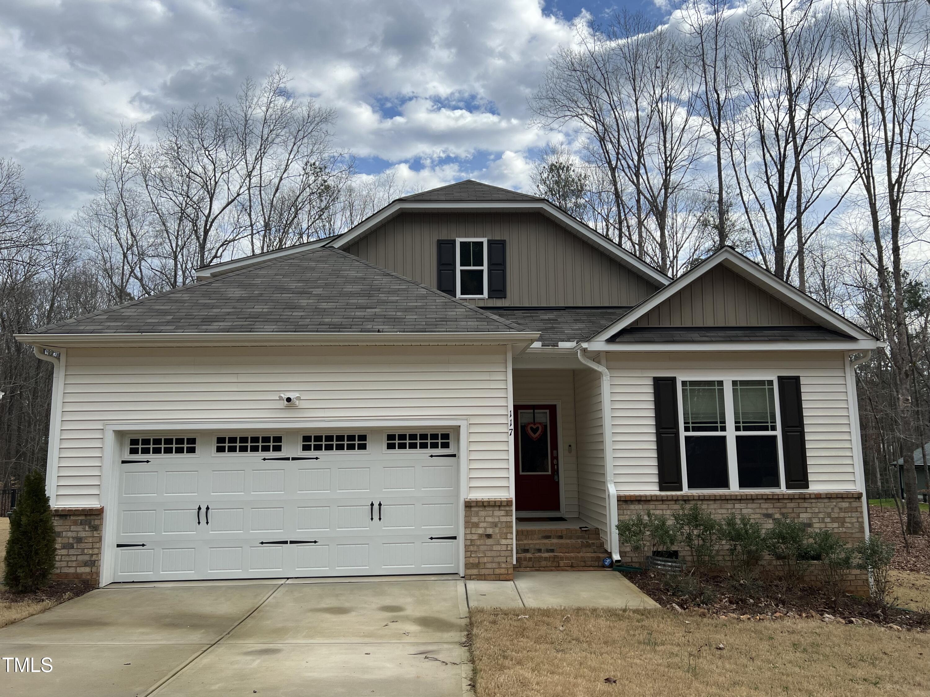 117 Clear Water Road Louisburg, NC 27549 - Photo 1 of 34 a front view of a house with a yard and garage