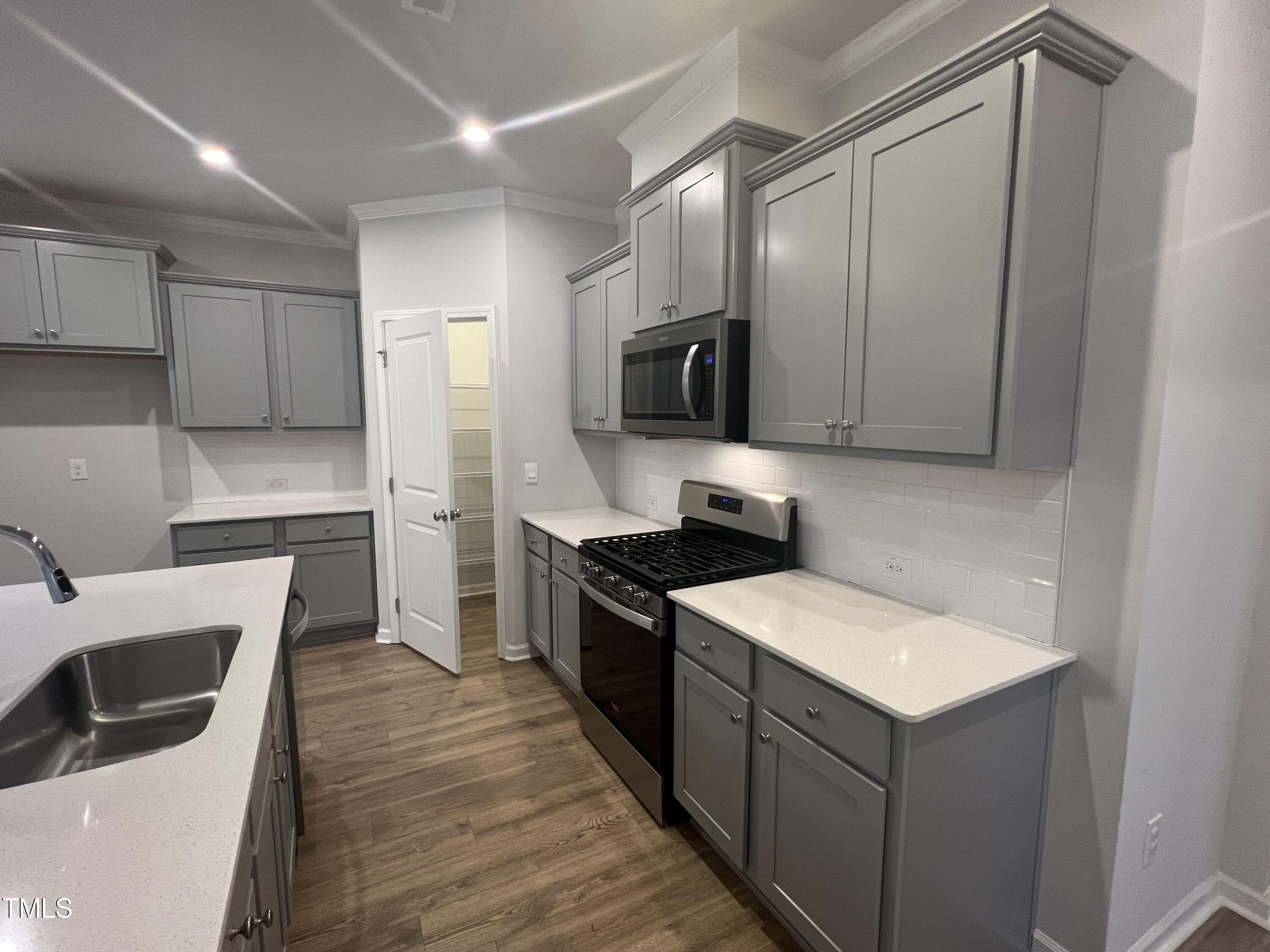 117 Clear Water Road Louisburg, NC 27549 - Photo 10 of 34 a kitchen with a sink and a stove top oven