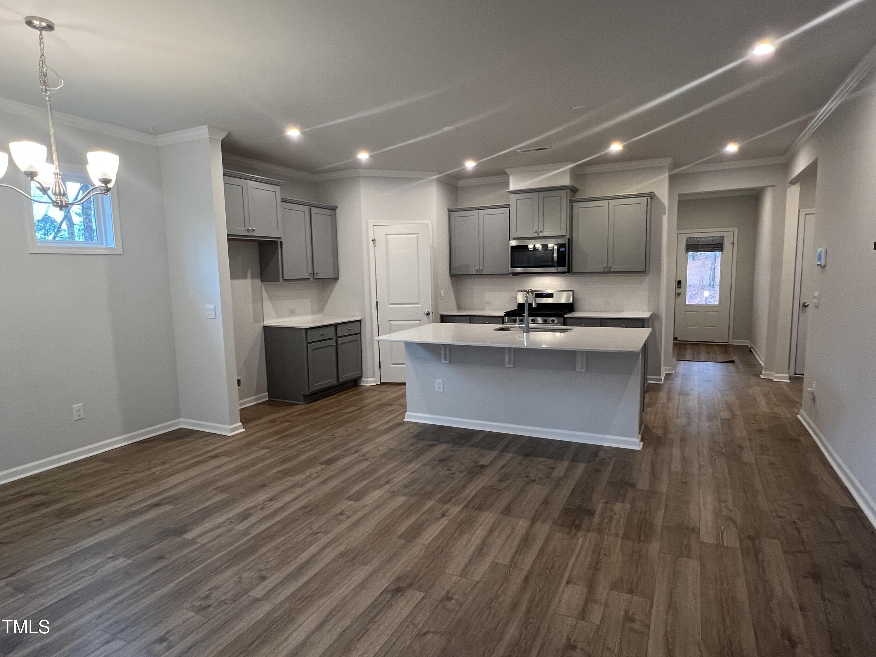 117 Clear Water Road Louisburg, NC 27549 - Photo 13 of 34 a kitchen with kitchen island a sink a stove and cabinets