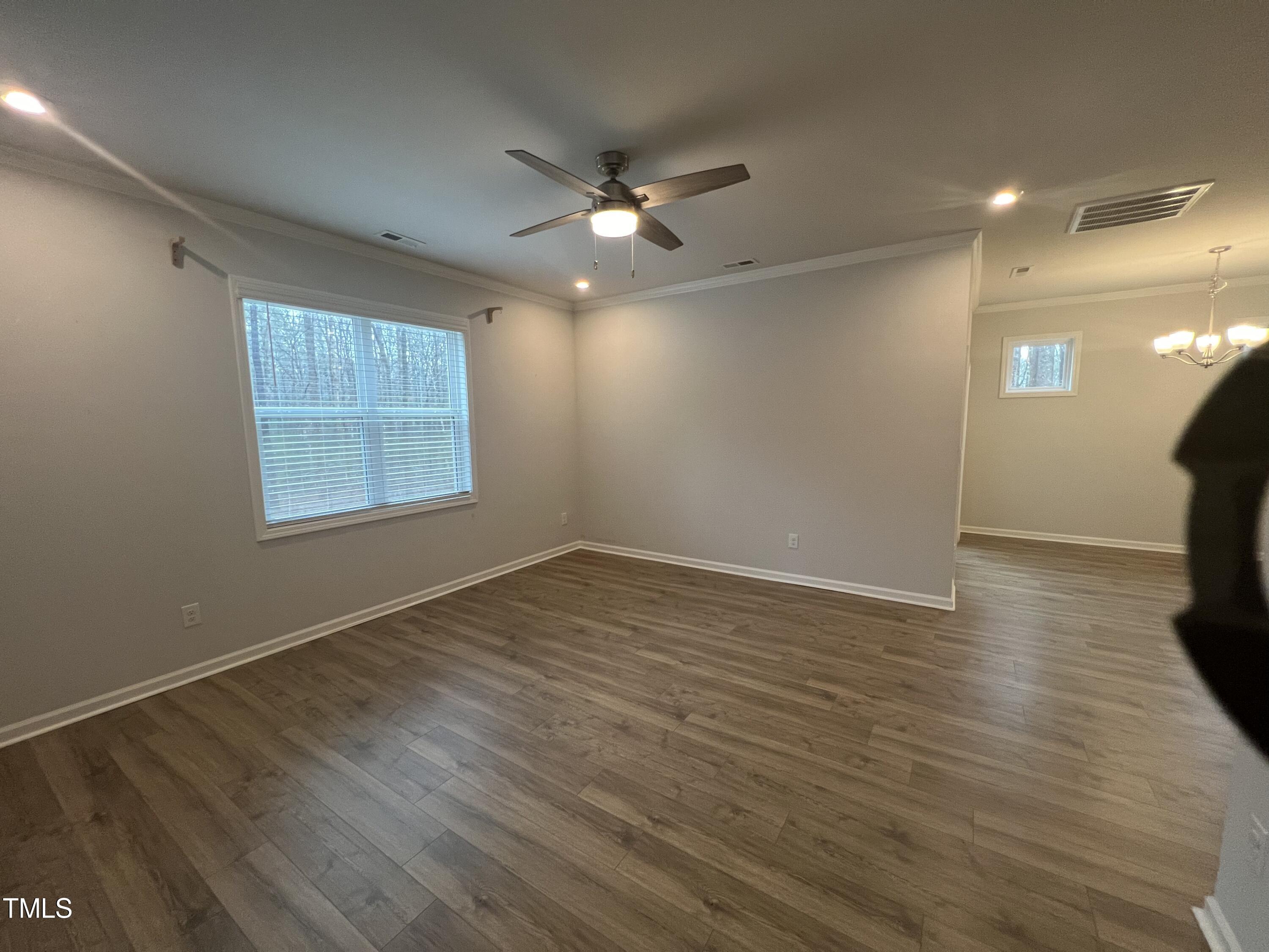 117 Clear Water Road Louisburg, NC 27549 - Photo 15 of 34 an empty room with wooden floor and windows
