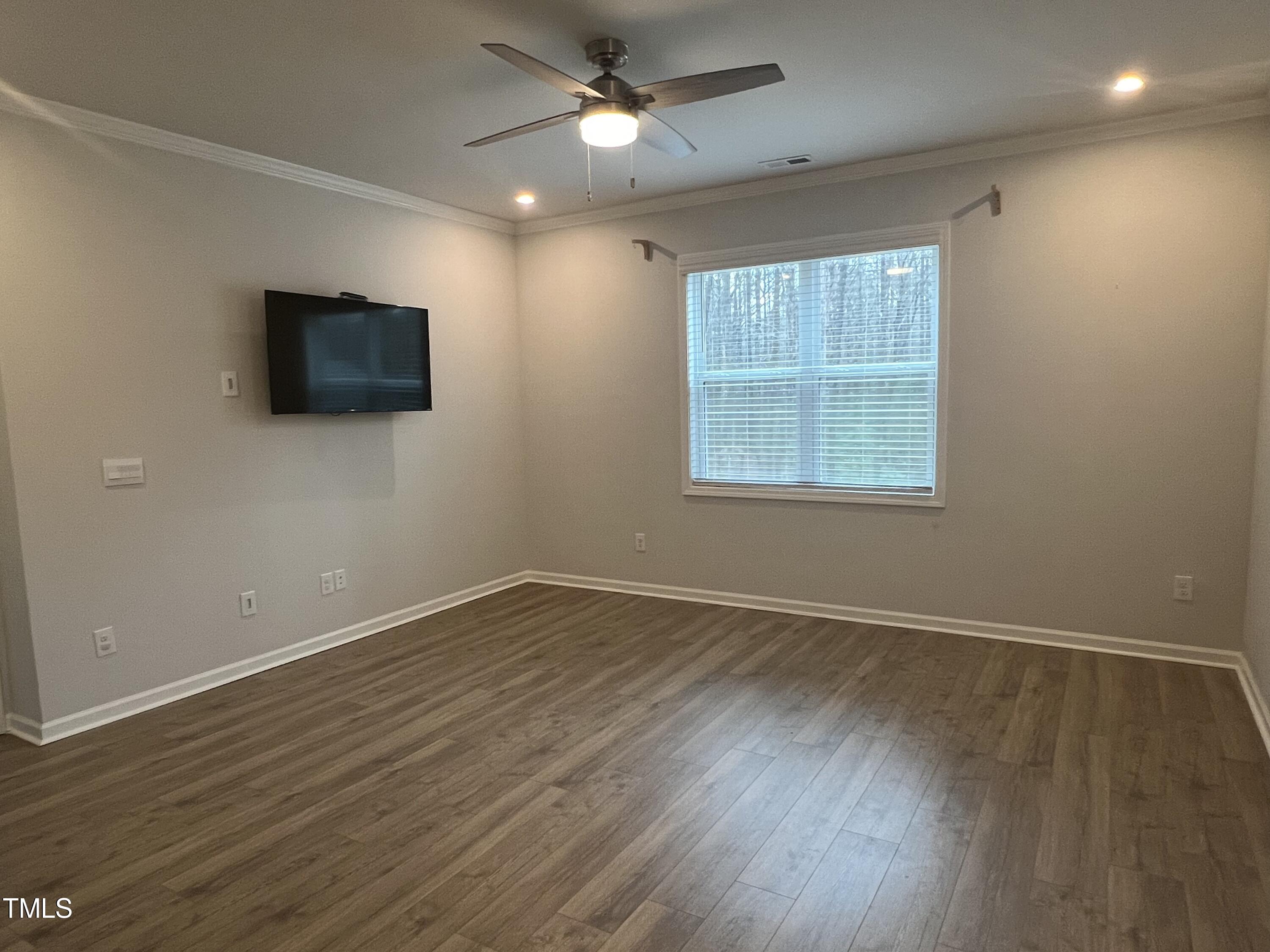 117 Clear Water Road Louisburg, NC 27549 - Photo 16 of 34 an empty room with wooden floor and windows