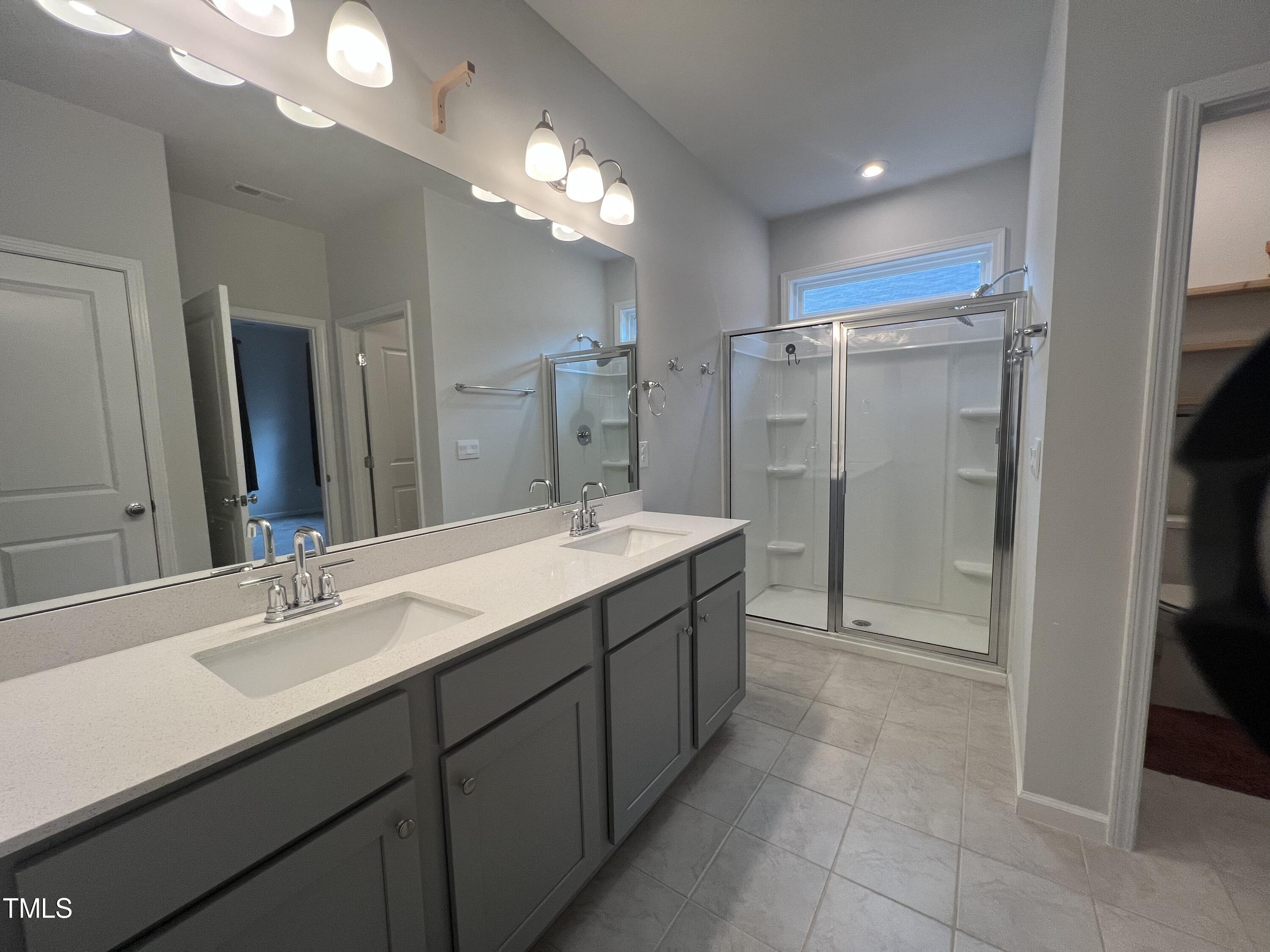 117 Clear Water Road Louisburg, NC 27549 - Photo 20 of 34 a bathroom with a double vanity sink mirror and shower