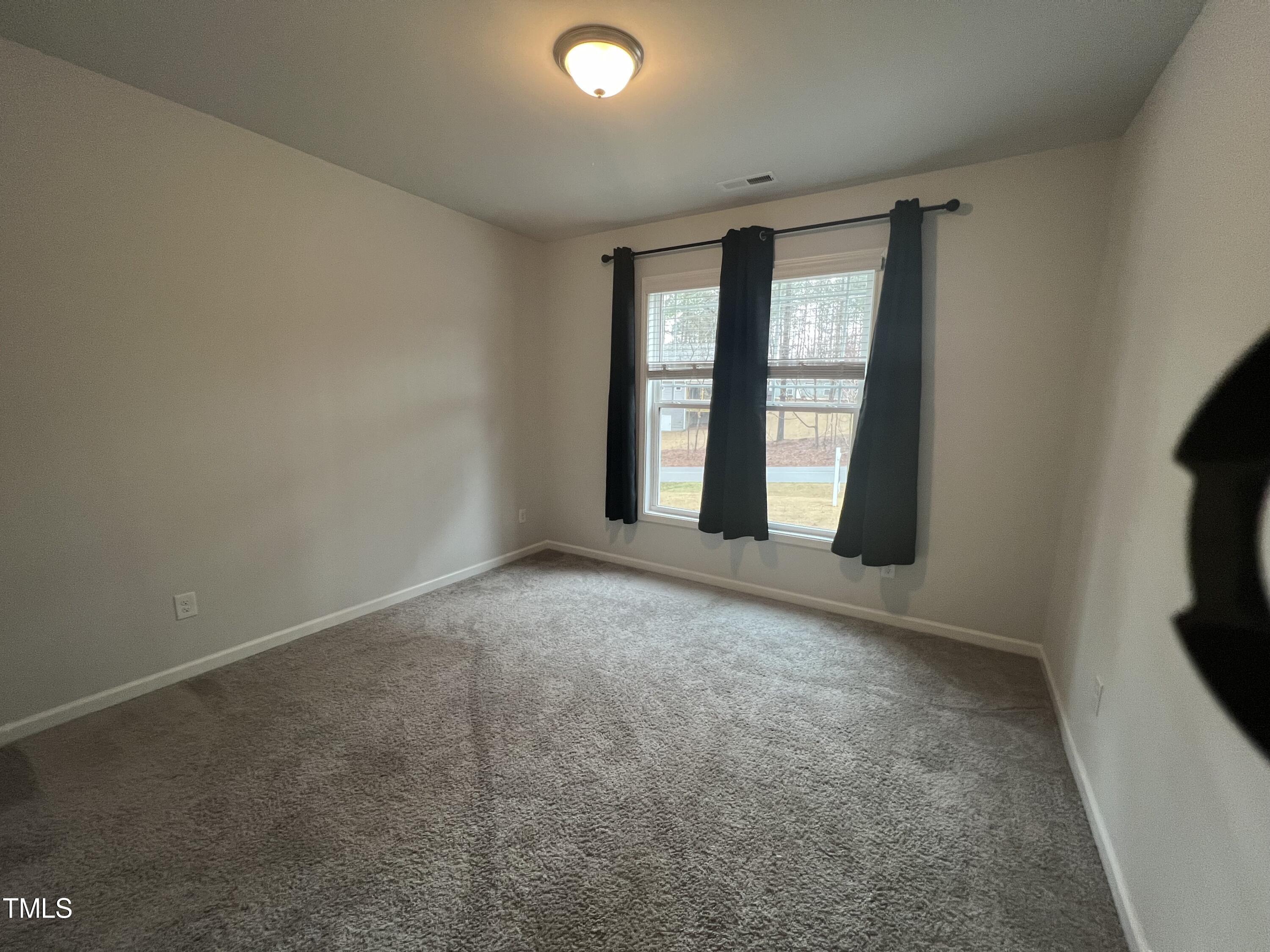 117 Clear Water Road Louisburg, NC 27549 - Photo 22 of 34 an empty room with windows