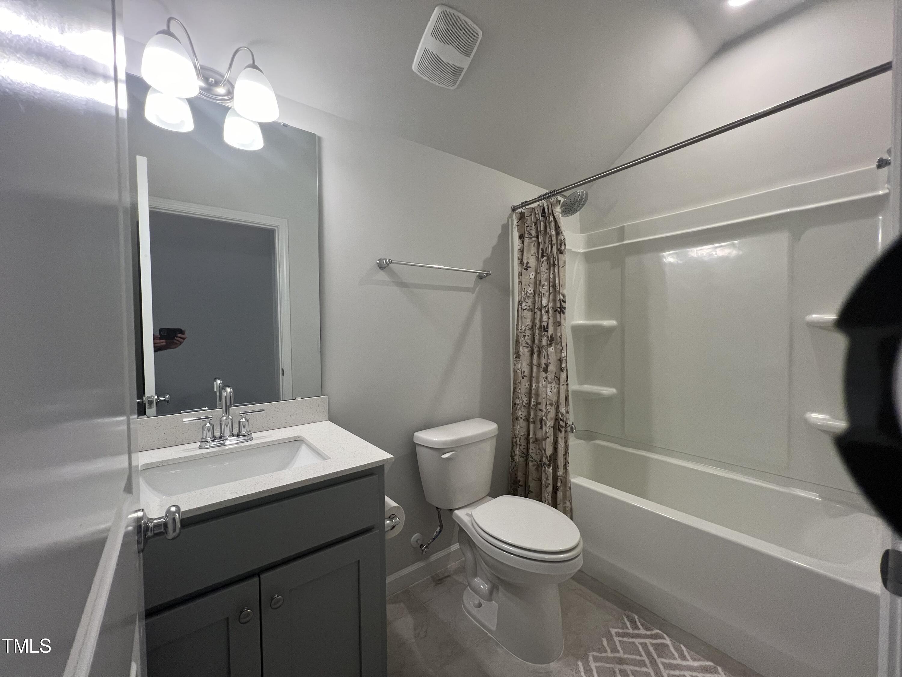 117 Clear Water Road Louisburg, NC 27549 - Photo 29 of 34 a bathroom with a sink a toilet a mirror and shower