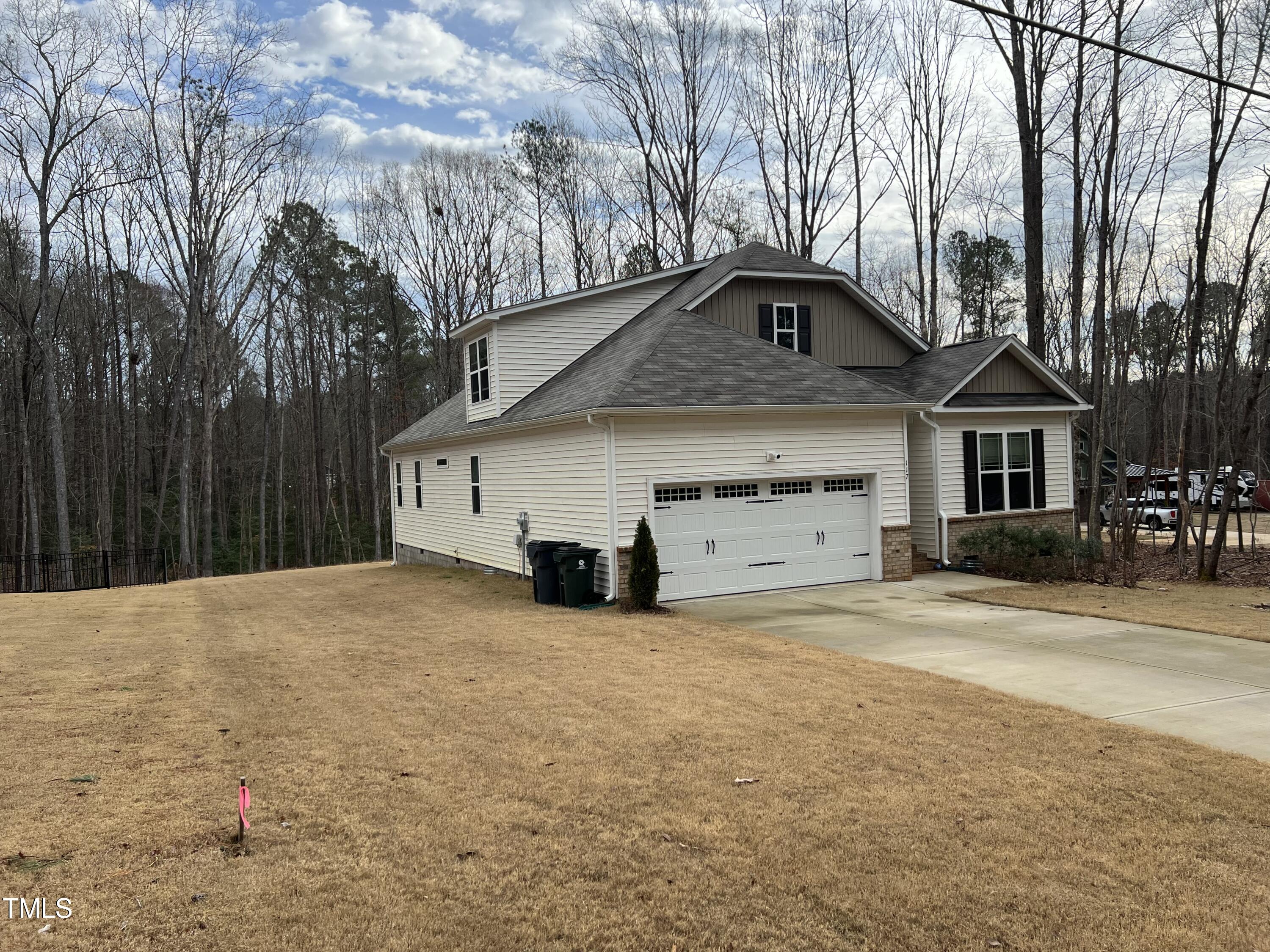 117 Clear Water Road Louisburg, NC 27549 - Photo 3 of 34 a front view of a house with a yard and garage