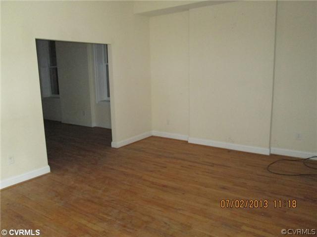 1417 Decatur Street Richmond, VA 23224 - Photo 3 of 8 an empty room with wooden floor