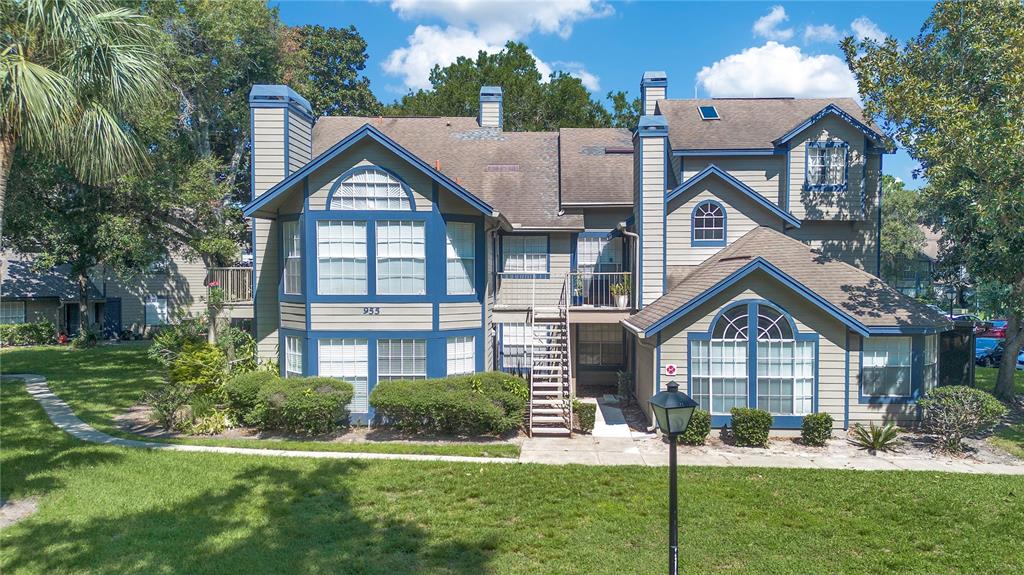 a view of a house with a yard and plants
