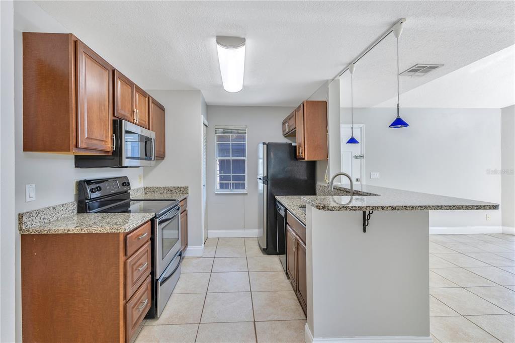 955 Forest Ridge Court, Unit 203 Lake Mary, FL 32746 - Photo 14 of 26 a kitchen with a sink stove and cabinets