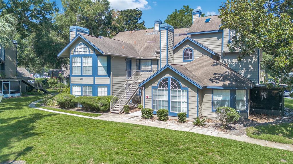 955 Forest Ridge Court, Unit 203 Lake Mary, FL 32746 - Photo 2 of 26 a front view of a house with a yard and porch
