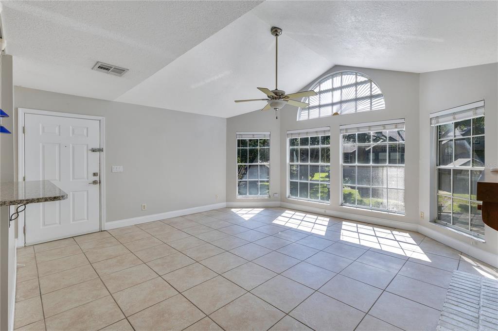 955 Forest Ridge Court, Unit 203 Lake Mary, FL 32746 - Photo 10 of 26 a view of an empty room with a chandelier