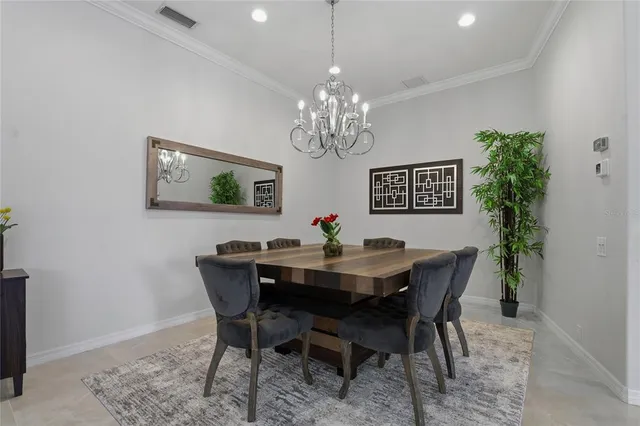 a kitchen with stainless steel appliances kitchen island granite countertop a stove top oven a sink a refrigerator and white cabinets