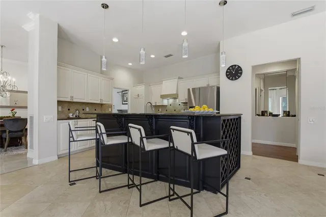 a utility room with cabinets and wooden floor