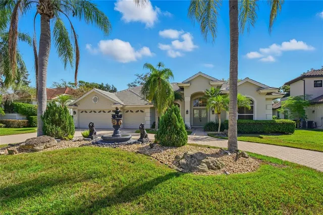 a view of a house with backyard and sitting area