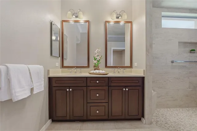 a bathroom with a double vanity sink and a mirror