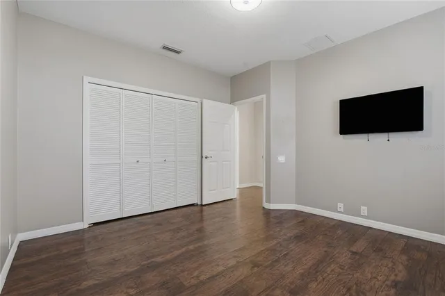 a bathroom with a granite countertop toilet sink and mirror
