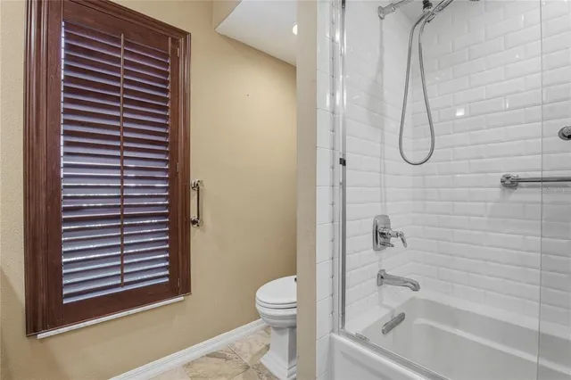 a view of a backyard with wooden floor and iron fence