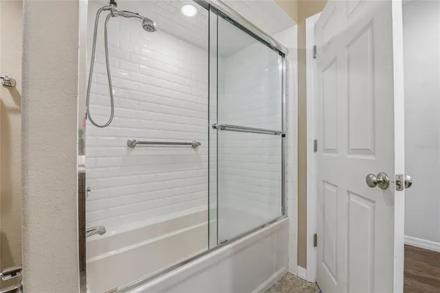 a view of a room with a flat screen tv a ceiling fan and window