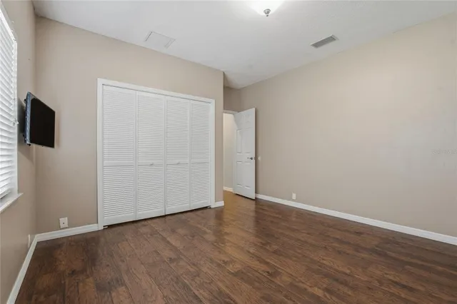 a view of a dining room with furniture a kitchen and chandelier