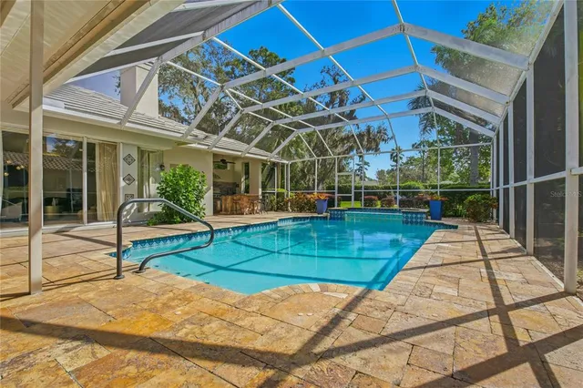 an aerial view of residential house with outdoor space and trees